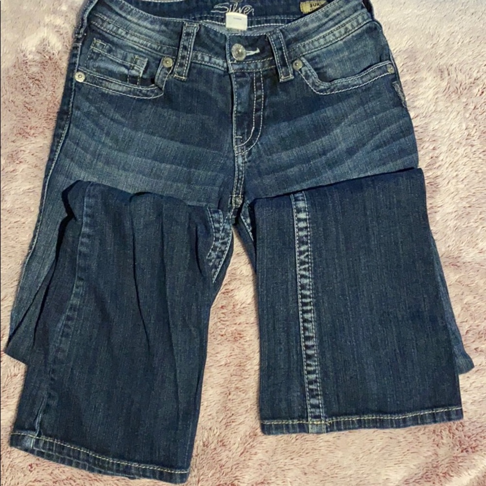 Boot cut silver jeans.